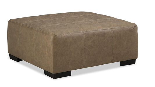 A beige upholstered ottoman with a rectangular shape and flat base.