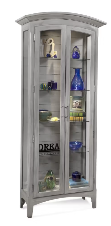 Gray curio cabinet with glass doors displaying various items on a white background