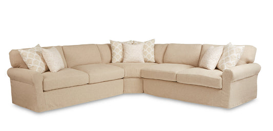Beige sectional sofa with decorative pillows on a white background