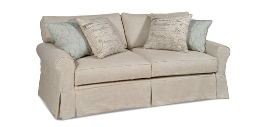 Beige loveseat with patterned cushions on a white background