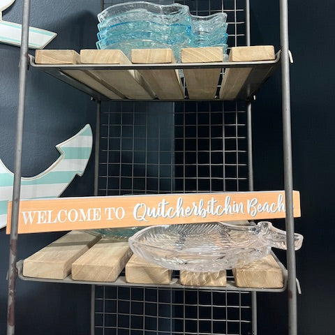 Wooden crate with decorative items against a tiled wall