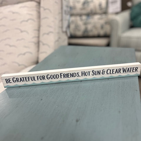 Decorative sign on a coffee table with a living room background