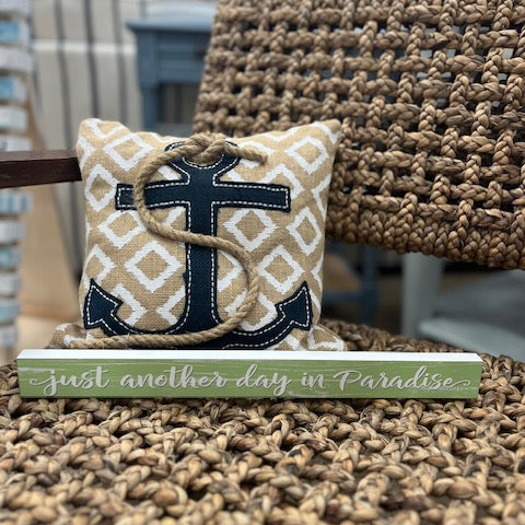 Decorative pillow with anchor design on a textured surface