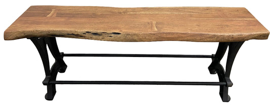 A dining bench with a live edge wooden seat and a metal frame.