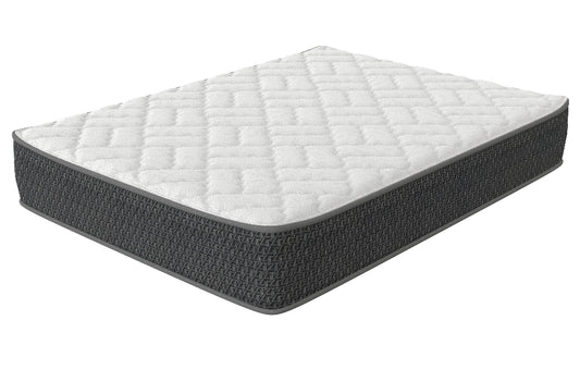 A firm mattress with a white and gray geometric pattern on the surface.