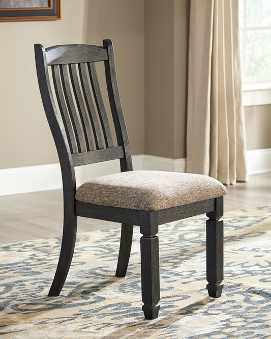Wooden dining chair with upholstered seat on a patterned rug