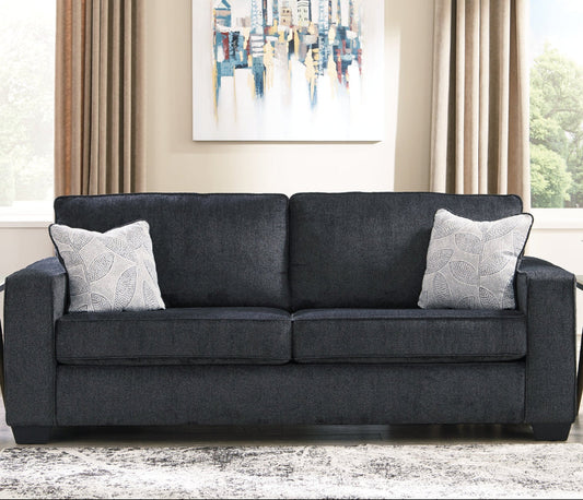 Gray sofa with decorative pillows in a living room setting