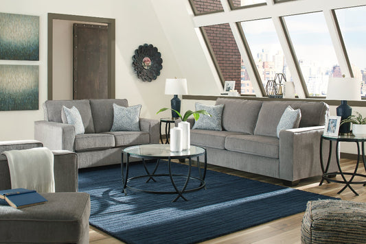 Living room with gray sofa, coffee table, and decorative items.