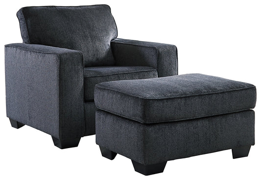 Gray upholstered armchair with matching ottoman on a white background