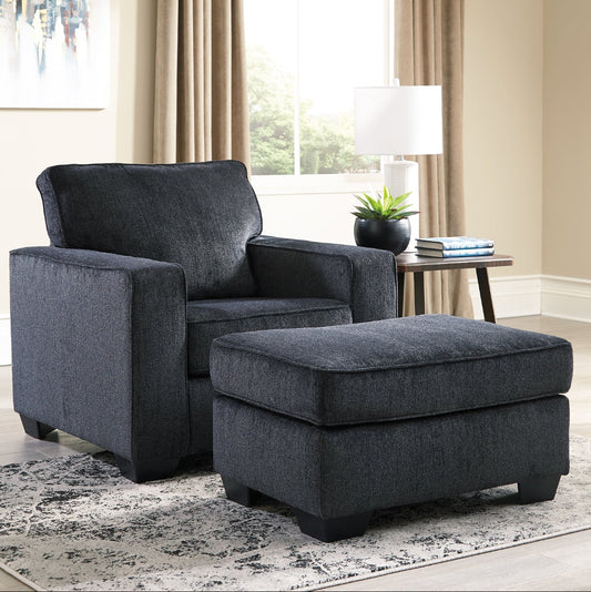 Gray armchair with matching ottoman in a living room setting.