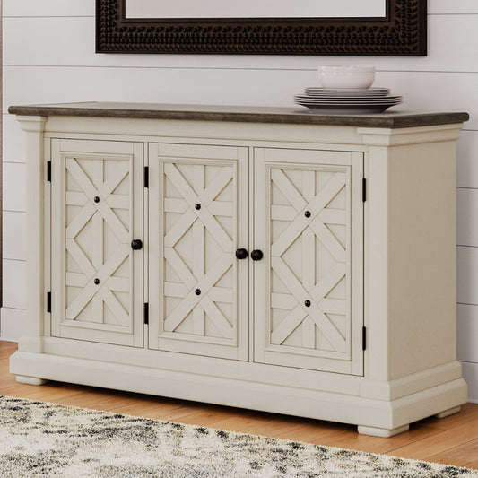 White cabinet with decorative doors in a room with a plant and framed picture on the wall.