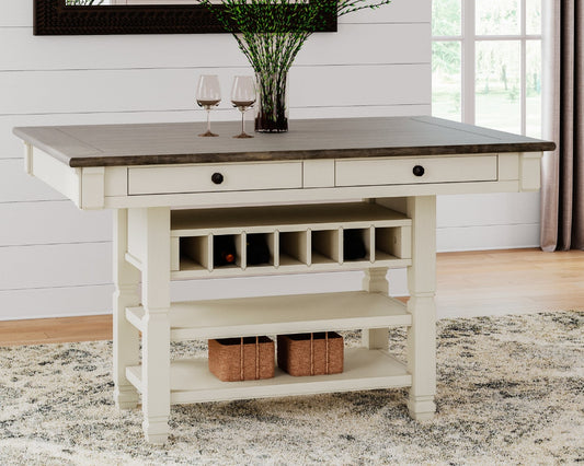 White kitchen island with wooden top in a room with white walls and a rug.