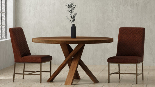 Dining room with wooden table and chairs against a textured wall.