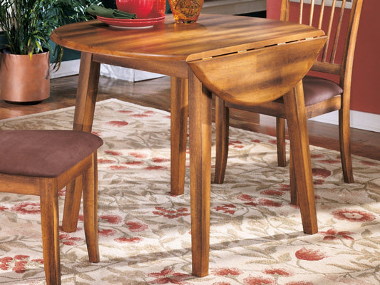 Wooden dining table with chairs on a patterned rug