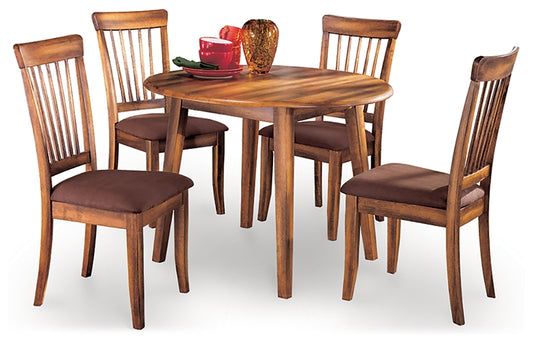 Wooden dining table set with four chairs on a white background