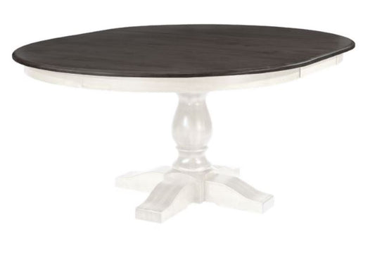 A round dining table with a wood tabletop and a white aproned leaf extending from the table. The table has a solid wood leg and a white base.