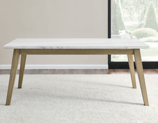 Dining table with marble top and wooden legs in a minimalistic room.