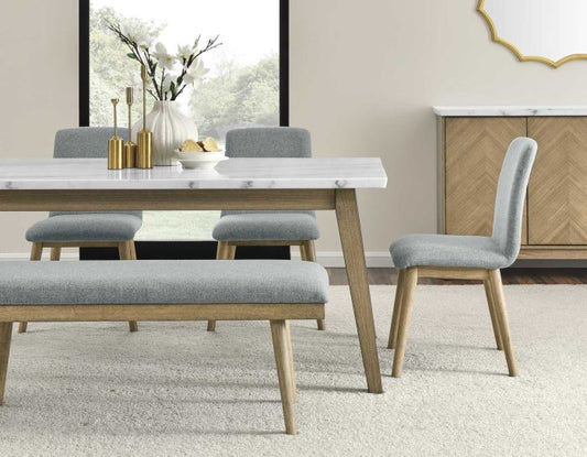 A 6-piece dining set with a marble top table, blonde wood legs, a gray upholstered bench, and four gray upholstered chairs.