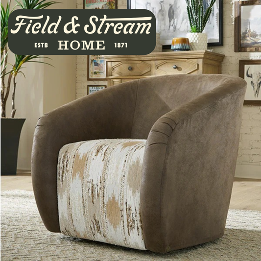 A brown upholstered armchair with a distressed cream and tan patterned seat cushion, shown in a styled living room. A dark green 'Field & Stream Home Estb.