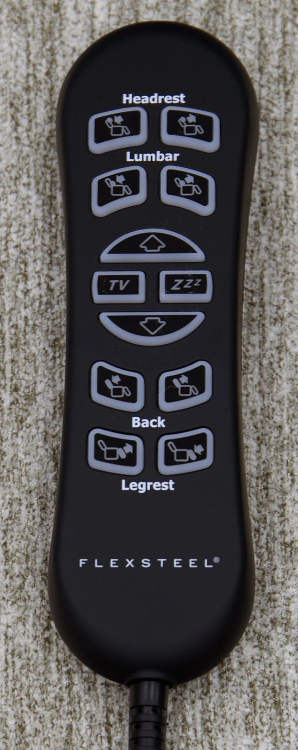 Black remote control with labeled buttons on a textured surface