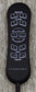 Black remote control with labeled buttons on a textured surface