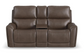 Brown leather sofa with storage compartments on a white background