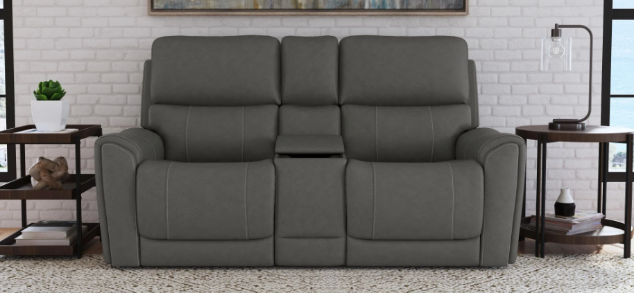 Gray reclining sofa in a living room setting with decor elements.