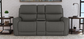 Gray reclining sofa in a living room setting with decor elements.