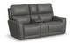 Gray leather reclining sofa with cup holders on a white background