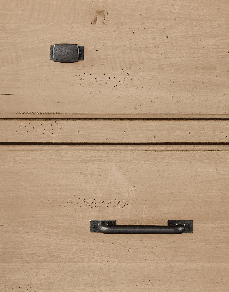 Close-up of wooden furniture with metal handles on a beige background