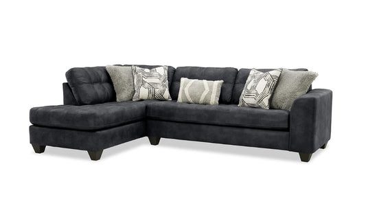 black sectional sofa with patterned cushions on a white background