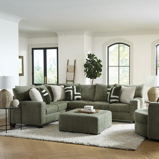 Modern living room with a green sectional sofa, armchair, and ottoman.