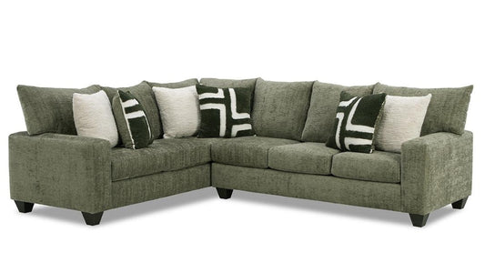 Green sectional sofa with patterned cushions on a white background