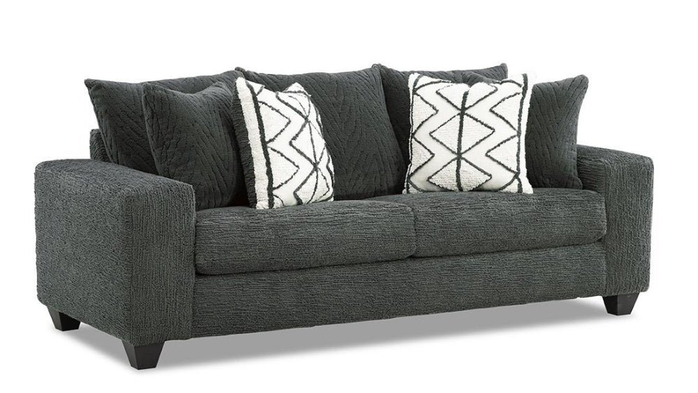 Gray sofa with patterned cushions on a white background
