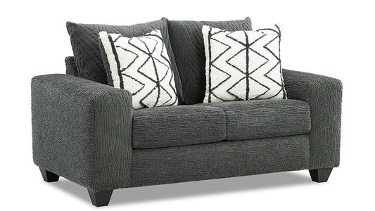 Gray loveseat with patterned cushions on a white background