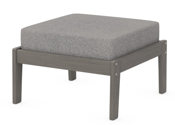A gray cushioned deep seating ottoman with a driftwood frame, made from all-weather materials suitable for outdoor use.