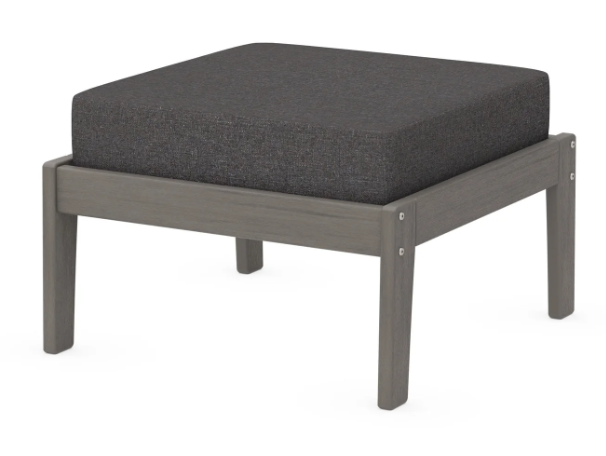 A dark gray cushioned deep seating ottoman with a driftwood frame, made from all-weather materials suitable for outdoor use.