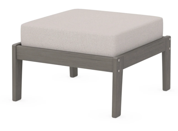 A cream cushioned deep seating ottoman with a driftwood frame, made from all-weather materials suitable for outdoor use.