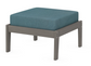 A teal cushioned deep seating ottoman with a driftwood frame, made from all-weather materials suitable for outdoor use.