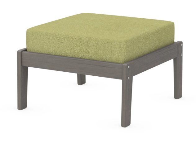 A green cushioned deep seating ottoman with a driftwood frame, made from all-weather materials suitable for outdoor use.