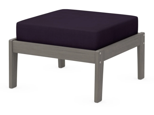 A dark blue cushioned deep seating ottoman with a driftwood frame, made from all-weather materials suitable for outdoor use.