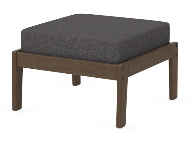 A dark gray cushioned deep seating ottoman with a kona frame, made from all-weather materials suitable for outdoor use.
