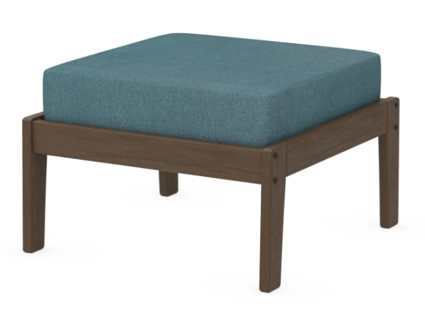 A teal cushioned deep seating ottoman with a kona frame, made from all-weather materials suitable for outdoor use.