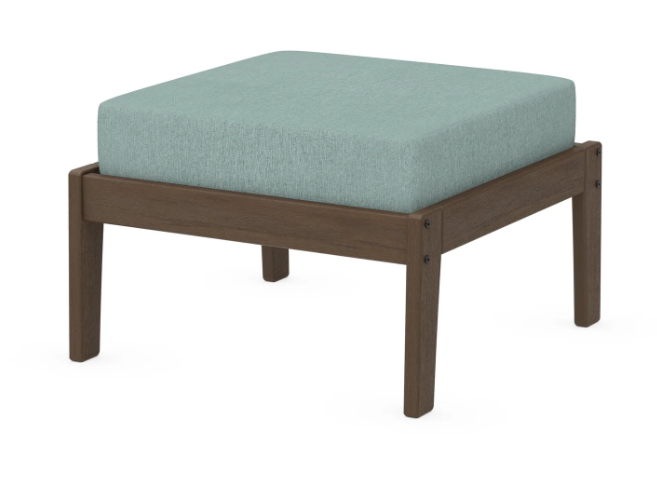 A light blue cushioned deep seating ottoman with a kona frame, made from all-weather materials suitable for outdoor use.
