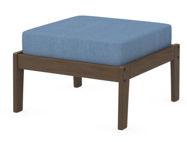 A blue cushioned deep seating ottoman with a kona frame, made from all-weather materials suitable for outdoor use.
