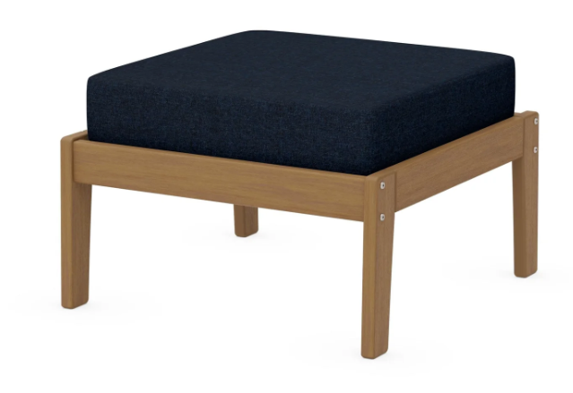 A navy cushioned deep seating ottoman with a natural frame, made from all-weather materials suitable for outdoor use.