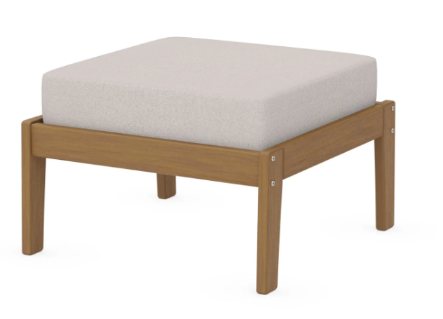 A cream cushioned deep seating ottoman with a natural frame, made from all-weather materials suitable for outdoor use.
