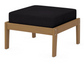 A dark blue cushioned deep seating ottoman with a natural frame, made from all-weather materials suitable for outdoor use.