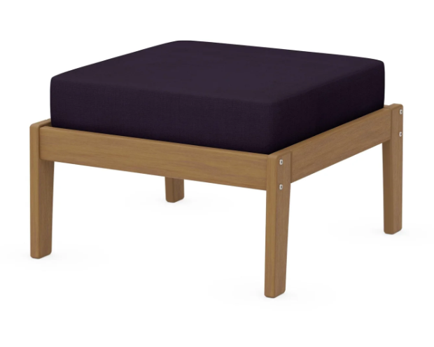 A dark blue cushioned deep seating ottoman with a natural frame, made from all-weather materials suitable for outdoor use.