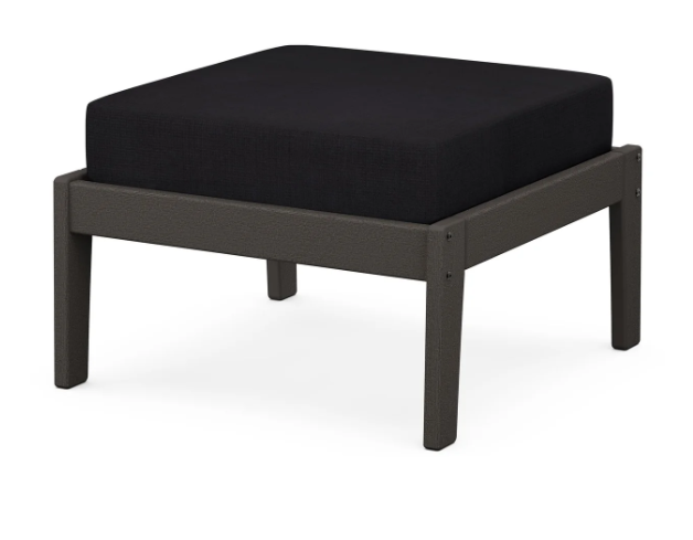A navy cushioned deep seating ottoman with a vintage coffee frame, made from all-weather materials suitable for outdoor use.